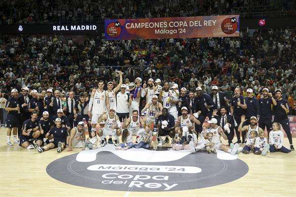 Los jugadores del Real Madrid celebran con la copa la victoria ante el Barça, proclamandose campeones de la Copa del Rey de baloncesto este domingo, en el Palacio de los Deportes José María Martín Carpena, en Málaga. EFE/ Daniel Pérez