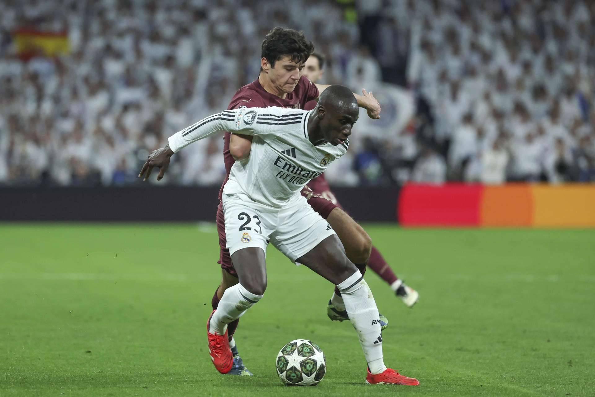El defensa francés del Real Madrid Ferland Mendy (d) ante Abdukodir Khusanov (i), del Manchester, en foto de archivo de Kiko Huesca. EFE