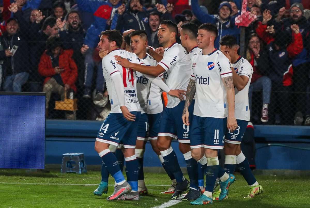 Luis Suárez (c) del Nacional celebra hoy con sus compañeros tras anotar contra Rentistas, su primer gol en el Clausura uruguayo, durante un partido por la segunda fecha del torneo en el estadio Gran Parque Central, en Montevideo (Uruguay). EFE/Raúl Martínez