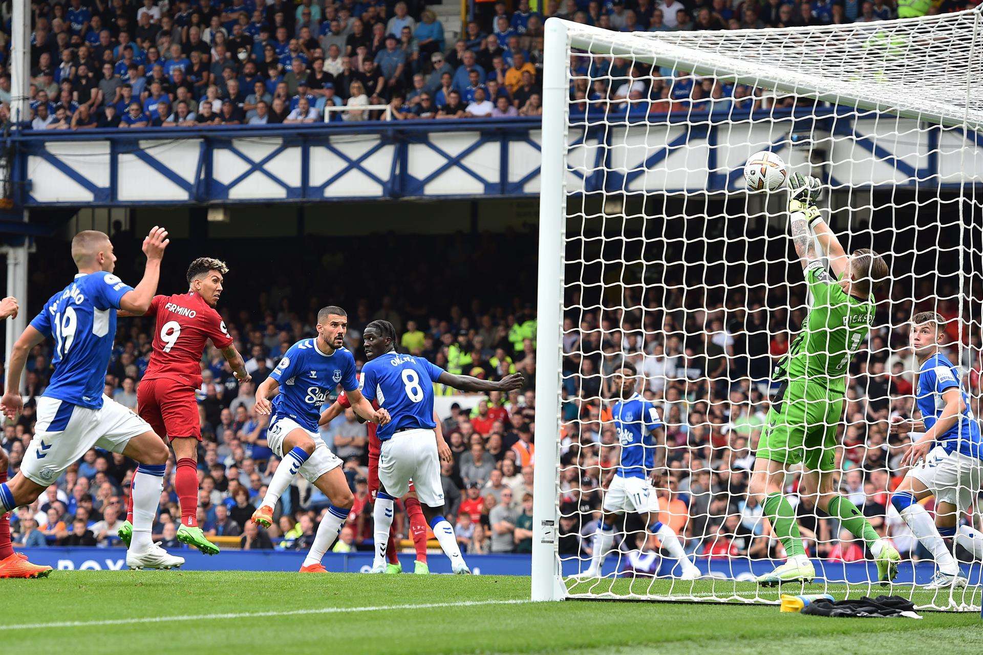 El portero del Everton, Jordan Pickford, salva un remate de Roberto Firmino durante el partido contra el Liverpool. EFE/EPA/PETER POWELL
