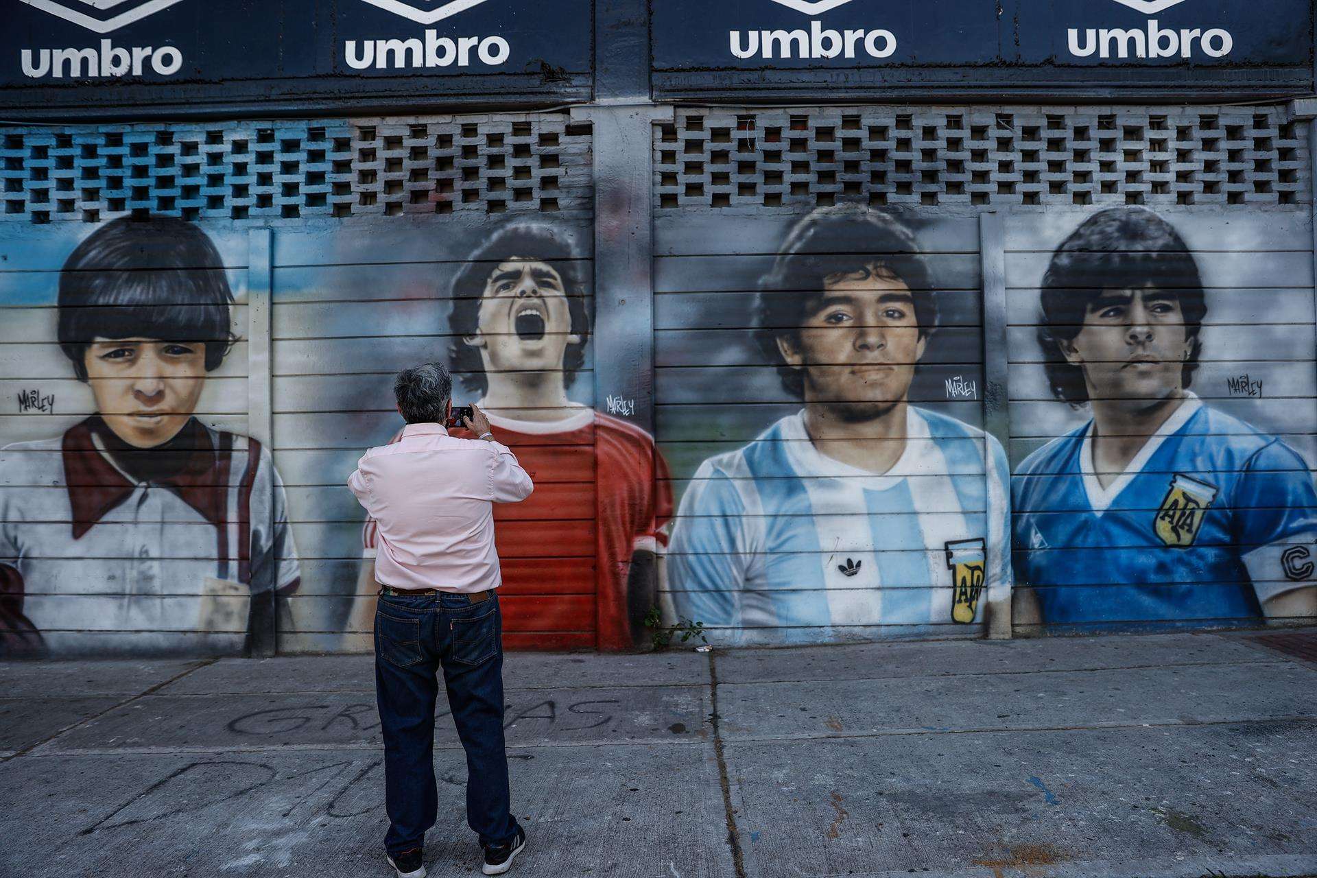 Un hombre toma una foto a un mural sobre Diego Armando Maradona en el estadio de Argentinos Juniors, en Buenos Aires (Argentina), en una fotografía de archivo. EFE/Juan Ignacio Roncoroni