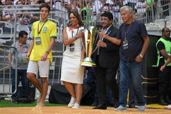 El presidente de la Confederación Brasileña de Fútbol (CBF), Enaldo Rodrigues (2-d), y la hija de Edson Arantes do Nascimiento 'Pelé', Flavia Arantes Nascimento (2-i), ingresan con el trofeo al campo en la final de la Supercopa de Brasil entre Palmeiras y Sao Paulo en el estadio Mineirao en Belo Horizonte (Brasil). EFE/ Yuri Edmundo
